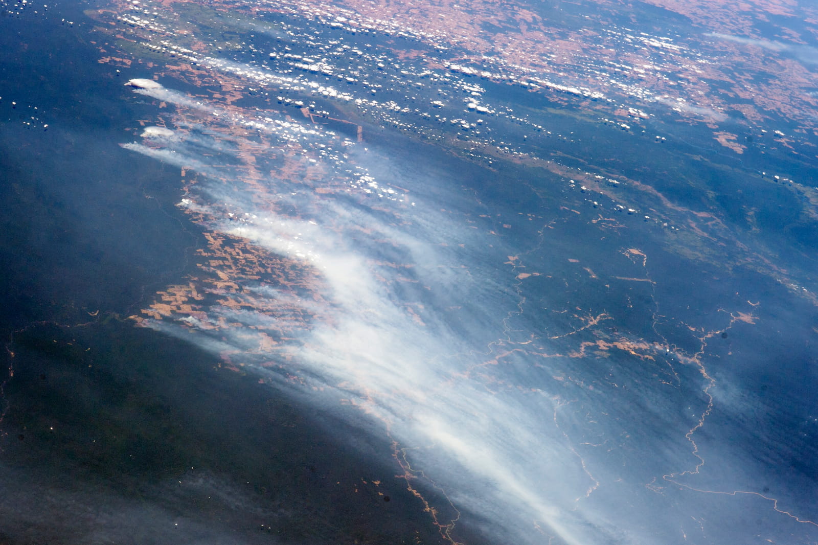 Astronaut photograph of Amazon rainforest fires and deforestation along highway BR-163, Brazil